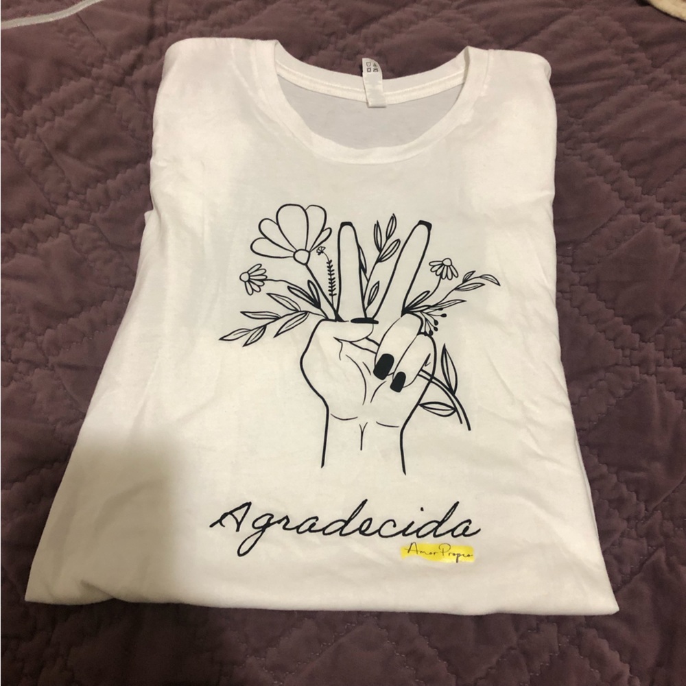 Never worn Large white t-shirt with a hand holding flowers giving peace sign.
